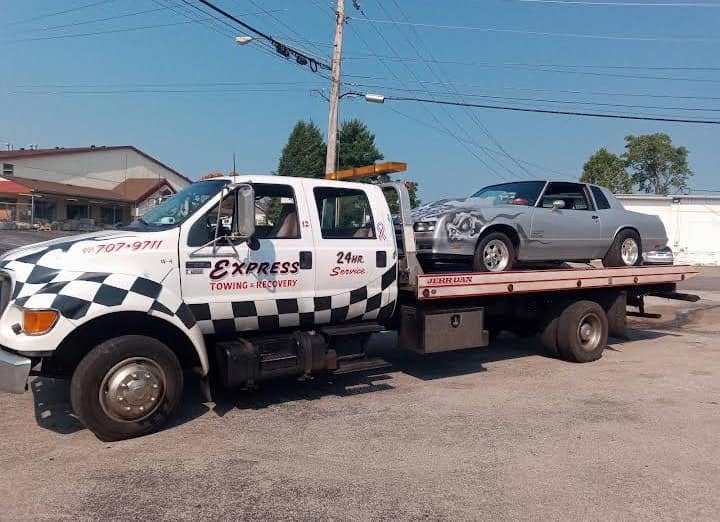 Express Towing and Recovery flatbed transporting a car